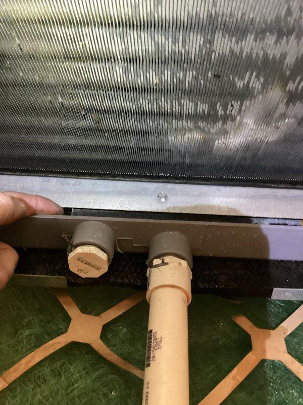 Responded to no cooling complaint with reported water accumulation near furnace. Upon inspection, found condensate drain system with evidence of moisture issues at evaporator coil section. Examined evaporator coil showing dirt accumulation on aluminum fins and inspected condensate drain pan beneath unit. Verified drain line connections and push-fit fittings on condensate drainage system. Identified potential blockage or drainage restriction causing water backup. Cleaned drain pan, cleared condensate line obstruction, and verified proper drainage flow. Tested system operation and confirmed cooling function restored with proper condensate removal. Recommended routine maintenance to prevent future coil fouling and drain line blockages.