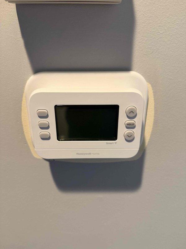 Conducted comprehensive HVAC system evaluation for residential property with aging 25-30 year old equipment requiring replacement. Assessed existing dual outdoor condenser units and indoor components, documented current Honeywell Home smart thermostat, and photographed equipment conditions to provide accurate replacement estimate for new air conditioning unit and heat exchanger system.