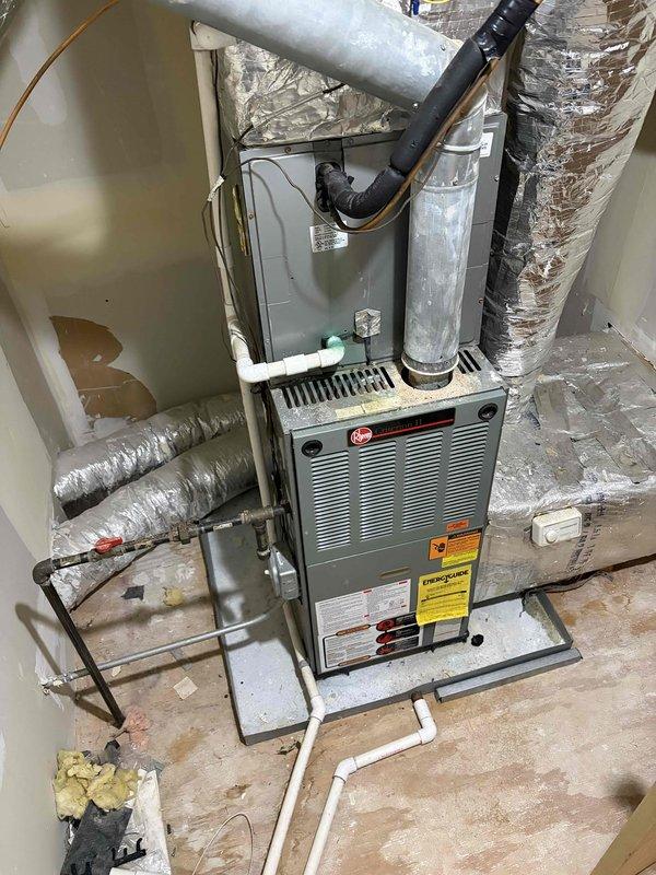 Conducted comprehensive HVAC system evaluation for 22-year-old residential heating and cooling equipment located in basement utility area. Assessed existing Rheem furnace, air handler unit, ductwork configuration, refrigerant lines, and associated mechanical components to provide complete system replacement recommendations. Documented current installation conditions including flexible ductwork connections, PVC condensate drainage, copper refrigerant piping, and overall system layout to determine optimal replacement specifications and equipment requirements.