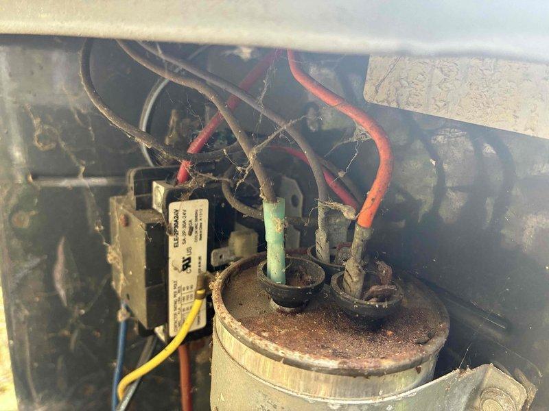 Responded to no cooling complaint on residential air conditioning system. Upon inspection, found dual run capacitor severely corroded and deteriorated, preventing proper compressor and condenser fan motor operation. Replaced failed capacitor with new component, verified proper electrical connections, and tested system operation. Unit now cooling properly with all components functioning within normal parameters.