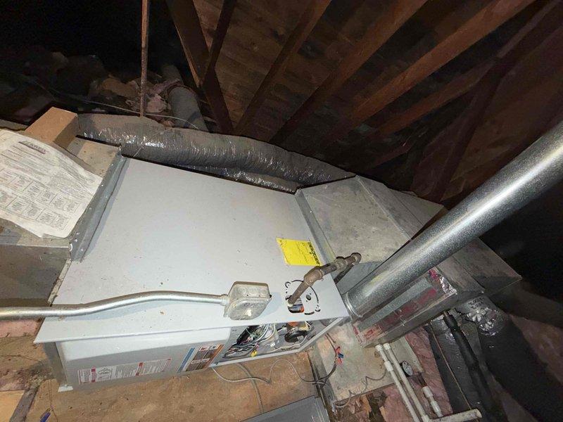 Conducted onsite inspection of existing attic-mounted HVAC system to assess replacement requirements. Evaluated current air handler unit, flexible ductwork configuration, and associated drainage systems including PVC condensate lines. Documented equipment condition, noting aged installation with disturbed insulation and existing duct connections. Photographed attic installation layout including equipment positioning, ductwork routing, electrical connections, and clearance requirements for replacement planning. Provided comprehensive free estimate for complete AC unit replacement based on inspection findings.