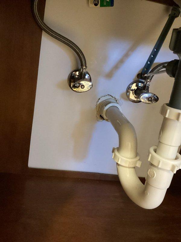 Completed comprehensive whole home plumbing inspection examining all accessible fixtures, supply lines, drain systems, and connections throughout the property. Inspected bathroom sink plumbing including chrome-plated supply lines with braided flexible hoses, shut-off valves, and white PVC P-trap configuration, confirming proper installation and absence of leaks. Evaluated laundry room plumbing connections for washing machine and dryer, checking drainage components and supply line integrity. All photographed areas showed proper plumbing installation with no visible defects or immediate concerns requiring repair.