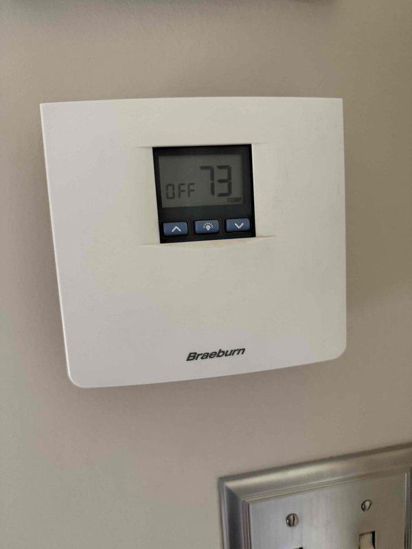 Conducted comprehensive assessment of aging residential HVAC system for replacement estimate. Evaluated existing outdoor condensing unit and Space Pak high-velocity air conditioning system, both exceeding 15 years of service life. Inspected condenser unit exterior condition, refrigerant line set routing, and electrical connections. Documented current thermostat configuration showing Braeburn digital control unit. Photographed equipment placement, copper line set condition showing oxidation typical of aged installations, and gravel pad foundation supporting outdoor unit. Provided property owner with detailed replacement options for complete system upgrade including new condensing unit and Space Pak equipment to restore efficient climate control operation.