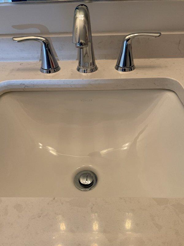 Responded to service call for slow-draining bathroom sink. Upon inspection, identified blockage in pop-up drain assembly causing restricted water flow. Removed and cleaned pop-up stopper mechanism, clearing accumulated hair and debris from drain opening. Verified P-trap and drain line connections were secure with no leaks present. Tested drainage flow after clearing obstruction, confirming normal operation restored to sink.
