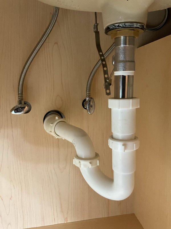 Responded to service call for slow-draining bathroom sink. Upon inspection, identified blockage in pop-up drain assembly causing restricted water flow. Removed and cleaned pop-up stopper mechanism, clearing accumulated hair and debris from drain opening. Verified P-trap and drain line connections were secure with no leaks present. Tested drainage flow after clearing obstruction, confirming normal operation restored to sink.