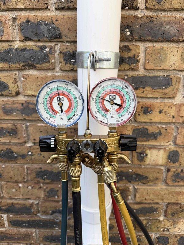 Completed routine HVAC maintenance agreement service on residential outdoor condensing unit. Performed standard system inspection, connected manifold gauges to verify refrigerant pressures and system performance, and documented equipment condition with photos. System operating within normal parameters; customer requested equipment information be updated in service tracking system.