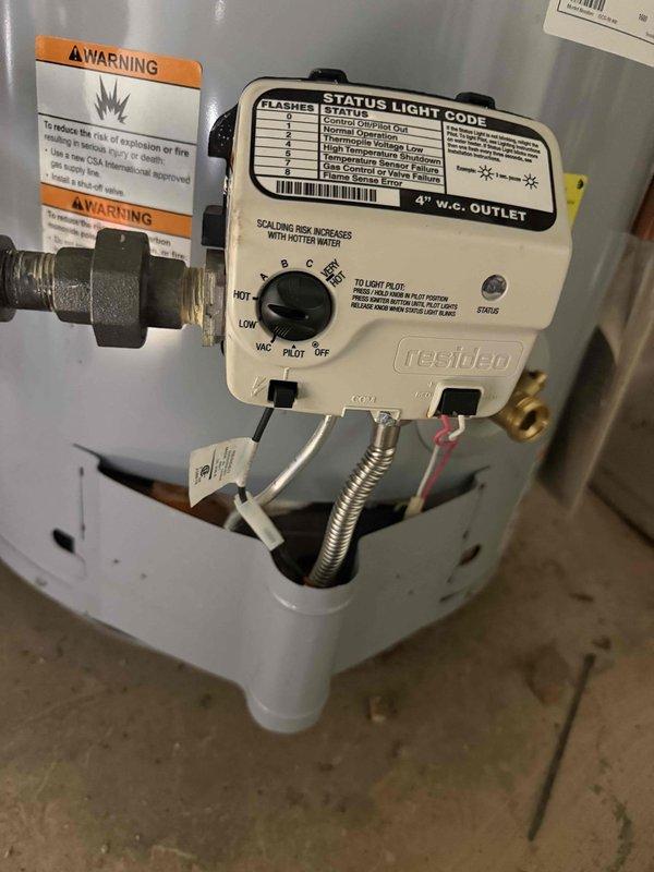 Returned to property to complete pilot assembly replacement on water heater. Installed new Resideo gas control valve assembly with rotary dial featuring OFF, PILOT, W.C., LOW, and HOT settings. Connected brass fittings and flexible metallic tubing to gas control unit rated at 4" w.c. outlet pressure. Verified proper installation of safety warning labels regarding explosion risks. Tested pilot ignition system and confirmed operational status using diagnostic indicator panel on control face. System now heating properly with all safety controls functioning as designed.