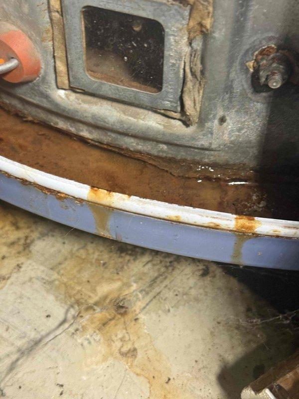 Responded to no hot water complaint and performed system inspection. Upon arrival, found boiler system with significant rust staining on drip pan and visible moisture accumulation, indicating potential leak or condensation issue. Inspected water heater, furnace connections, and associated copper piping throughout utility closet. Identified aging copper pipes with oxidation and discoloration. Checked all valves, fittings, and colored hose connections between components. Addressed immediate issue to restore hot water service and documented equipment condition for customer awareness of system age and wear patterns.