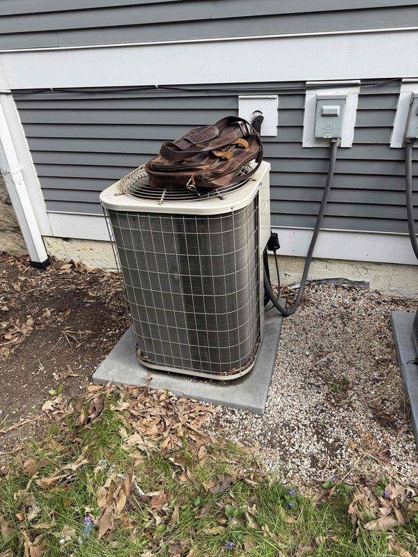 Technician completed an HVAC estimate for air conditioning system replacement on a 2017 first-floor unit with easy accessibility. The existing condenser unit showed signs of age and weathering, located on a concrete pad along the exterior wall with standard refrigerant line connections. Assessment included evaluation of repair versus replacement options for the aging system.