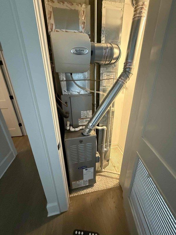 Completed cooling check on two residential air conditioning systems as part of Gold Service agreement. Verified thermostat operation showing proper temperature control set to 70°F cooling mode, inspected upstairs HVAC installation including furnace and Aprilaire air quality equipment with all components and ductwork in good working condition with no visible defects or maintenance concerns noted.