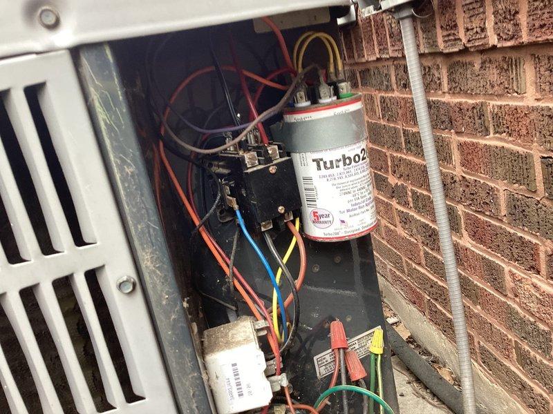Responded to service call for second opinion on 20-year-old residential air conditioning unit with no cooling condition and suspected refrigerant leak. Upon arrival, performed comprehensive system evaluation including visual inspection of outdoor condensing unit, electrical components, and refrigerant circuit. Connected manifold gauge set to service ports and confirmed low refrigerant charge with abnormal pressure readings on both high and low sides, indicating significant refrigerant loss. Inspected capacitor, contactor, and wiring harness for proper operation and connections. Verified compressor electrical components and control circuits functioning within specifications. Documented system condition with photographs showing pressure gauge readings and internal electrical compartment including Turbo200 capacitor and associated wiring. Confirmed previous diagnosis of refrigerant leak and advised customer that due to advanced age of equipment (20+ years), locating and repairing leak fol