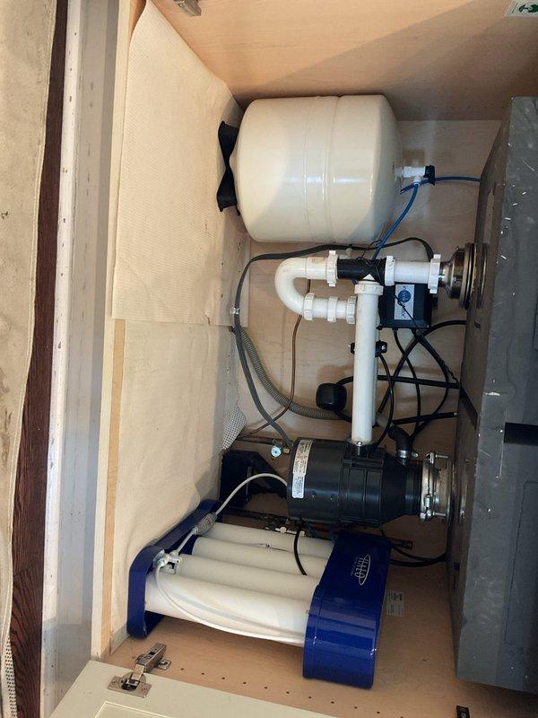 # HVAC Install - Boiler

Completed full boiler system replacement including new indirect water heater tank and comprehensive reverse osmosis water treatment system. Installation performed by three-person crew consisting of lead technician, helper, and licensed plumber over one-day period.

## Work Performed

Removed existing boiler and indirect tank, then installed new high-efficiency boiler system with indirect-fired water heater for domestic hot water supply. Completed all necessary piping connections, gas line modifications, and venting requirements per manufacturer specifications and local code requirements.

Installed complete reverse osmosis water filtration system within cabinet enclosure, featuring multi-stage filtration assembly with pressure tank, booster pump, and sediment/carbon filter housings. System mounted on plywood base with proper drainage and electrical connections. Configured PVC manifold with appropriate shut-off valves and connection points for system maintenance