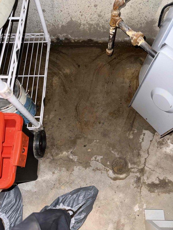 Responded to residential apartment for tanked water heater with pilot light failure. Upon arrival, inspected 15-year-old gas water heater located in basement utility room. Pilot light would not ignite or remain lit after multiple restart attempts. Performed diagnostic testing of thermocouple, gas control valve, and pilot assembly. Observed evidence of water damage on concrete floor surrounding unit, indicating previous or ongoing leakage. Given the age of the equipment and failed ignition system components, recommended full water heater replacement due to end of serviceable life expectancy and potential safety concerns with continued operation. Unit had reached typical lifespan for residential tanked water heaters and showed signs of deterioration. Provided property owner with replacement options and specifications for new installation.