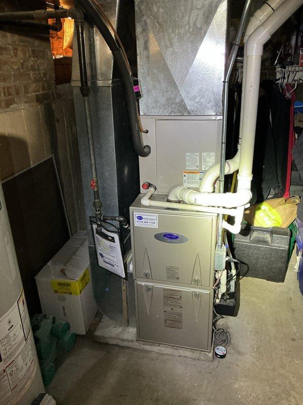 Completed preventive maintenance agreement service on residential Carrier furnace system and condenser unit. Inspected HVAC equipment in basement mechanical room, replaced 16x25x1 air filter, and verified proper operation of heating system components. Documented equipment condition with photos showing furnace, ductwork, and associated mechanical systems in functional working order.