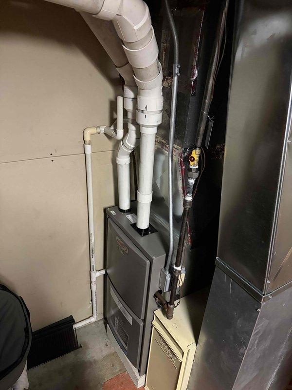 Conducted comprehensive evaluation of two existing HVAC systems, both over 20 years old with one unit currently non-operational. Assessed existing furnace units, ductwork configuration, refrigerant line conditions, and ventilation components in mechanical room. Documented equipment specifications, measured existing unit dimensions, and photographed current installation including PVC condensate piping, copper refrigerant lines with insulation, and electrical connections. Provided detailed estimate for complete replacement of both heating and cooling systems to restore full climate control functionality to the residence.