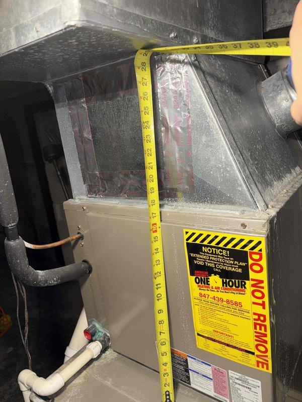 Conducted comprehensive evaluation of two existing HVAC systems, both over 20 years old with one unit currently non-operational. Assessed existing furnace units, ductwork configuration, refrigerant line conditions, and ventilation components in mechanical room. Documented equipment specifications, measured existing unit dimensions, and photographed current installation including PVC condensate piping, copper refrigerant lines with insulation, and electrical connections. Provided detailed estimate for complete replacement of both heating and cooling systems to restore full climate control functionality to the residence.