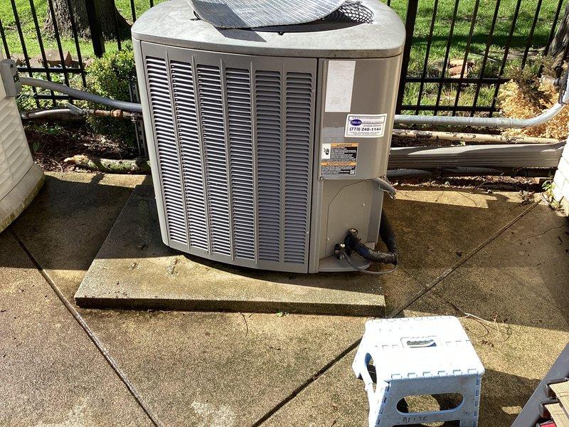 Completed comprehensive air conditioning maintenance agreement service on outdoor condensing unit and associated system components. Performed thorough inspection of cylindrical condenser unit with horizontal louvered vents, verified proper operation of fan assembly beneath protective grille, checked electrical disconnect box and conduit connections for secure mounting and proper function. Inspected indoor mechanical components including refrigerant lines with insulation wrapping, verified pressure gauge readings within manufacturer specifications, and examined all pipe connections and fittings for integrity. System operating within normal parameters upon completion of maintenance protocol.