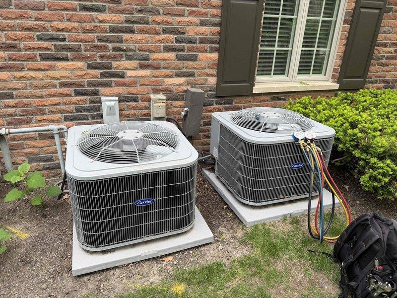 Completed semi-annual maintenance on two Carrier condensing units located on exterior concrete pads. Performed comprehensive inspection of both systems including condenser coil cleaning, refrigerant line examination, and electrical connection verification. Media filter replacement not included per service agreement specifications.