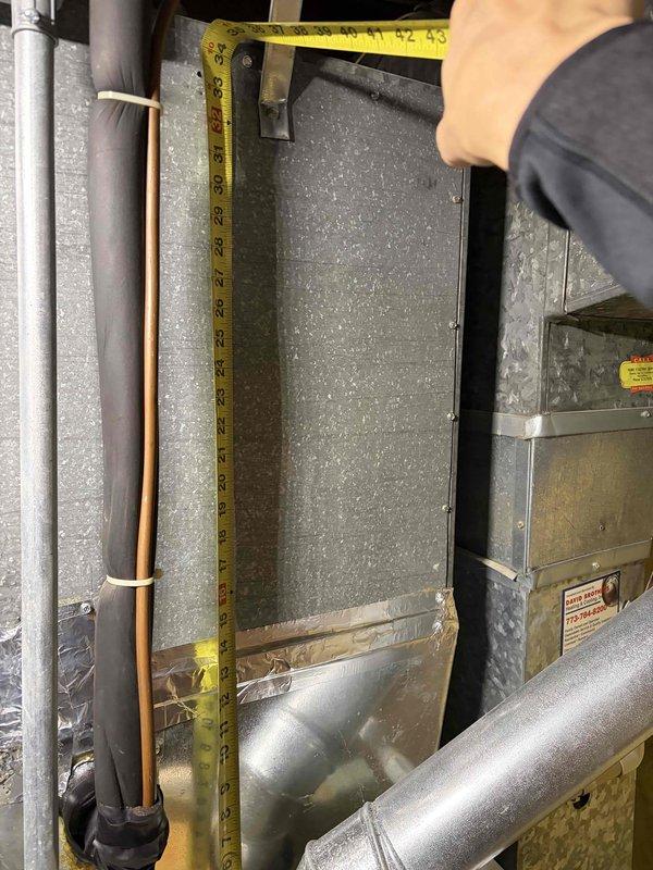 Conducted comprehensive assessment of existing residential HVAC system for replacement estimate. Inspected and documented current air handler unit and ductwork configuration in mechanical space, measuring existing equipment dimensions and clearances to determine proper replacement unit sizing. Evaluated copper refrigerant lines, insulated piping, and rigid metal ductwork connections for compatibility with new system installation. Photographed existing equipment setup including vertical duct runs, flexible aluminum ducting, and current air handler positioning to ensure accurate replacement specifications. Assessed electrical connections, mounting locations, and accessibility for future installation work.