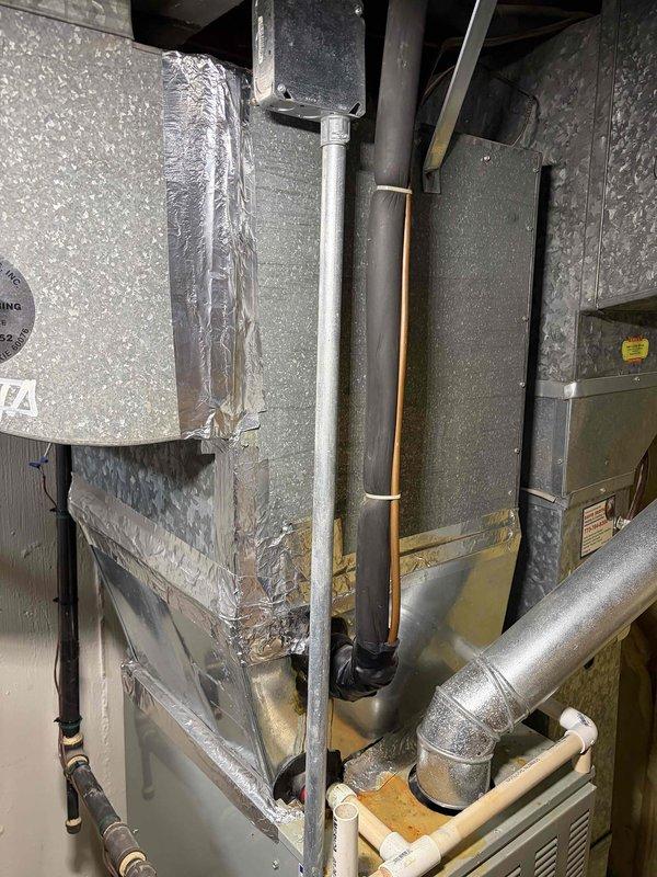 Conducted comprehensive assessment of existing residential HVAC system for replacement estimate. Inspected and documented current air handler unit and ductwork configuration in mechanical space, measuring existing equipment dimensions and clearances to determine proper replacement unit sizing. Evaluated copper refrigerant lines, insulated piping, and rigid metal ductwork connections for compatibility with new system installation. Photographed existing equipment setup including vertical duct runs, flexible aluminum ducting, and current air handler positioning to ensure accurate replacement specifications. Assessed electrical connections, mounting locations, and accessibility for future installation work.