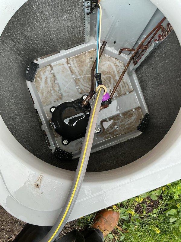 Completed comprehensive air conditioning maintenance inspection per maintenance agreement for single unit. Documented humidistat control settings on Aprilaire humidity control device, currently positioned at OFF setting, and inspected outdoor condensate pump system housed in below-grade access pit. Verified copper refrigerant lines, pump operation, and drainage components; noted existing staining in sump basin consistent with normal condensate discharge patterns.