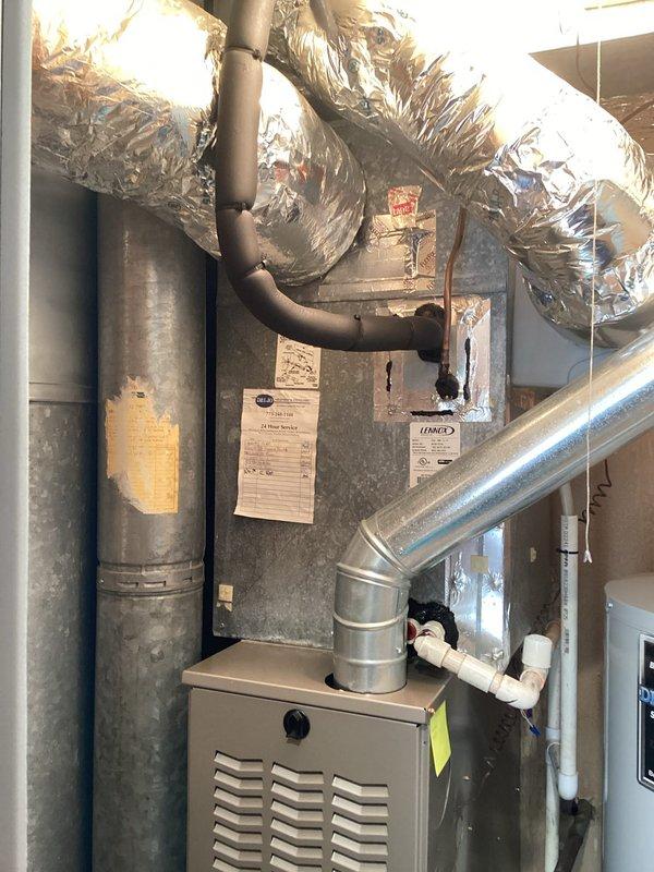 Completed preventive maintenance inspection on residential HVAC system including Lennox furnace unit and associated ductwork components. Performed visual inspection of equipment, verified proper operation of all mechanical systems, and documented current condition of furnace, ductwork, water heater connections, and related plumbing components with photographic evidence for maintenance records.