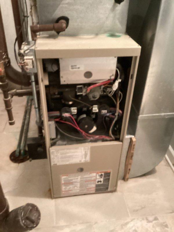 Completed HVAC maintenance agreement inspection on two air conditioning systems. During the inspection, identified and documented a safety concern with exposed wiring protruding from one of the condenser units. Photographed equipment data plates, internal components, and the wiring issue for service records and follow-up repair recommendations.