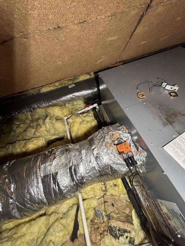 Technician responded to evaluate a 12-year-old R-410A air conditioning system located in the second-floor attic that was completely flat on refrigerant. System had a major leak and required refrigerant recharge the previous year, indicating ongoing refrigerant loss. Upon inspection, determined the unit was beyond economical repair due to age and severity of leak. Provided comprehensive repair options and replacement estimates to customer. Also identified that the first-floor air conditioning unit was low on refrigerant and requires attention. Documented equipment condition and access points with photos. Recommended full system replacement for the second-floor unit as the most cost-effective long-term solution.