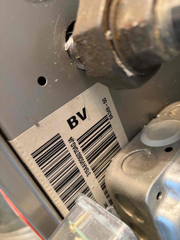 Conducted HVAC estimate for air conditioning system replacement at residential condominium unit. Evaluated existing 11-year-old rooftop AC condenser unit showing signs of age and wear, with visible dust accumulation on internal components. Assessed rooftop installation configuration with multiple HVAC units positioned on flat concrete surface within brick parapet enclosure, documented equipment specifications and existing installation conditions to provide replacement system recommendations.