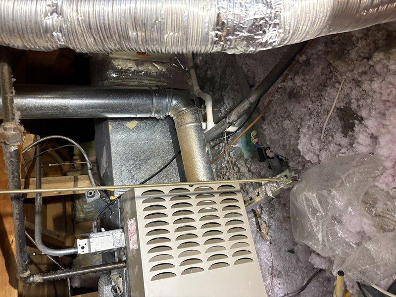 Conducted on-site assessment of two 23-year-old air conditioning units serving a two-zone residential system for replacement quote preparation. Documented existing equipment configuration, ductwork conditions, and installation environment through photographic documentation showing aged flexible ductwork with visible wear, existing air handler components with louvered panels, and exposed mechanical infrastructure in unfinished utility space. Confirmed property ownership and verified account information for estimate processing.