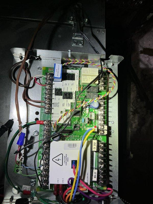 Responded to service call for air conditioning unit running continuously without shutting off. Upon arrival, accessed attic space via ceiling panel to inspect HVAC system and control board. Diagnosed faulty relay on main circuit board preventing system from cycling off when commanded by thermostat. Replaced defective relay component on green PCB control board, verified all wire terminal connections secure, and tested thermostat communication with system. Cycled unit through multiple on/off commands to confirm proper operation. System now responding correctly to thermostat inputs and shutting off as programmed.