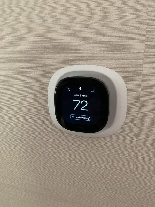 Performed New Gas Service clean and check on two air conditioning systems and diagnosed furnace heating issue. Inspected thermostat operation showing 72°F current temperature with system maintaining programmed setpoint of 73°F until 1:00pm. Examined air distribution components including curved vent registers which displayed dust accumulation on louvers and slats. Completed routine maintenance procedures on both AC units and investigated reported inadequate heating performance from furnace system.