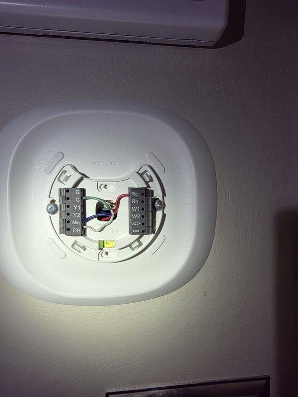 Completed warranty installation of new ecobee smart thermostat. Removed existing thermostat, properly terminated and labeled all HVAC wiring connections including Rc, Rh, W1, W2, and accessory wires to corresponding terminals on ecobee baseplate, mounted unit to wall, and verified system communication with air handler unit located in attic space.