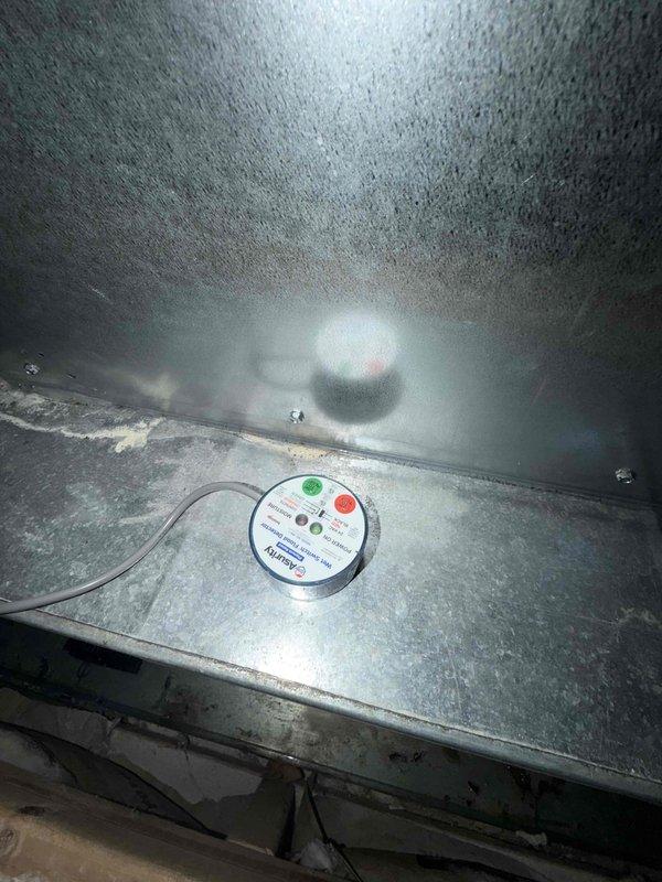Performed maintenance inspection on air conditioning system and addressed clogged condensate drain line. Cleared obstruction from drain pipe to restore proper drainage function and prevent water damage. Verified system operation and condensate flow, with monitoring equipment showing normal status indicators upon completion.