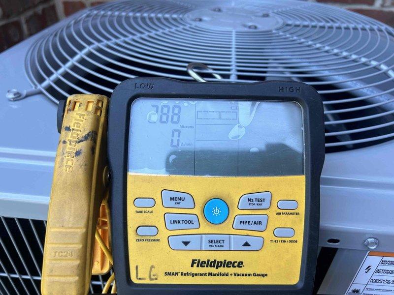 # Complete HVAC System Installation

Successfully installed a complete residential HVAC system including air conditioning unit, furnace, humidifier, and thermostat. The installation was completed by a two-person crew in a single day. The outdoor condensing unit was properly installed, charged with refrigerant, and evacuated to 288 microns to ensure system integrity. The air handler was mounted in the upper level space with properly insulated ductwork connections. All equipment was tested and verified operational before completion. Payment was collected upon job completion.