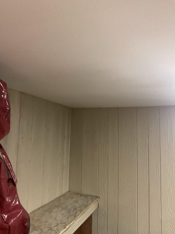 Completed inspection of 8-year-old frost-free hose bib requiring replacement at residential property. Examined exterior wall-mounted fixtures on red brick facade and assessed interior plumbing access point. Documented existing hose bib condition, wall penetration location, and surrounding infrastructure including downspout proximity to replacement area.
