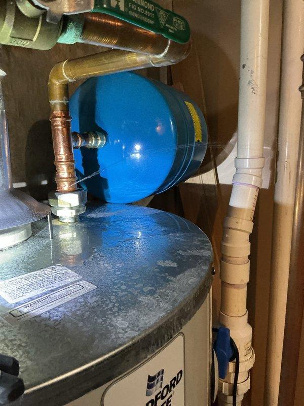 Responded to callback for water heater installed on 5/7 that was leaking at the cold water inlet connection. Upon arrival, inspected Bradford White water heater installation and identified leak at COTW (cold water top) connection. Tightened connection fittings and verified proper seal on expansion tank piping assembly. Tested system for leaks, confirmed no further water discharge, and verified proper operation of all plumbing connections.