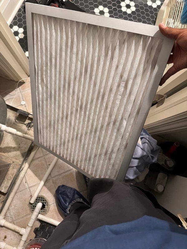 Responded to no cooling complaint on residential HVAC system. Upon arrival, customer was out of town and unit had been non-operational for multiple days per thermostat app notification. Inspected outdoor condensing unit and found failed dual run capacitor with visible aging, discoloration, and compromised wire connections. Replaced defective capacitor and verified proper electrical connections to compressor and condenser fan motor. Additionally inspected indoor air handler and found heavily soiled air filter restricting airflow, which contributed to system inefficiency and potential premature component failure. Replaced dirty filter with new pleated media filter to restore proper airflow. Cycled system through complete cooling operation and confirmed compressor startup, condenser fan operation, and adequate airflow at registers. System now cooling properly and operating within normal parameters.