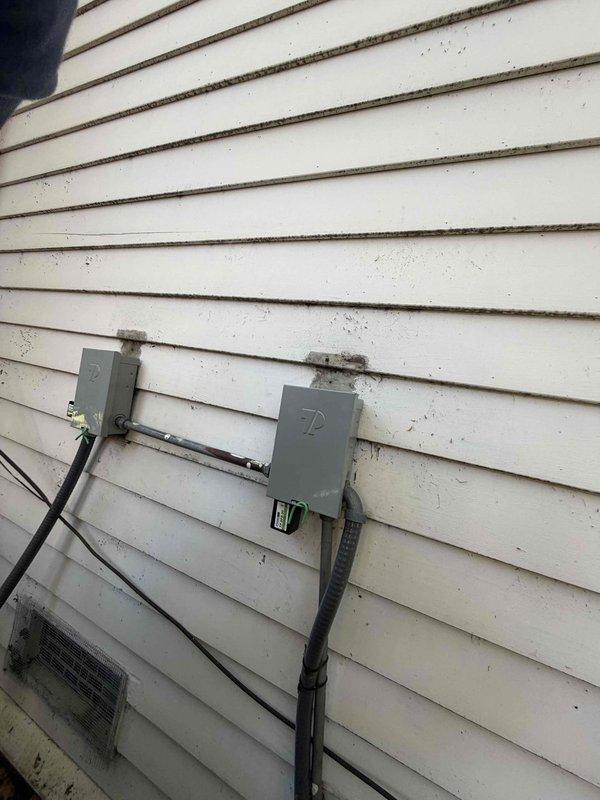 Replaced two existing electrical disconnect boxes on exterior wall with new units and installed two surge protectors to provide equipment protection. All electrical connections were properly secured, conduit runs completed, and system tested for proper operation.