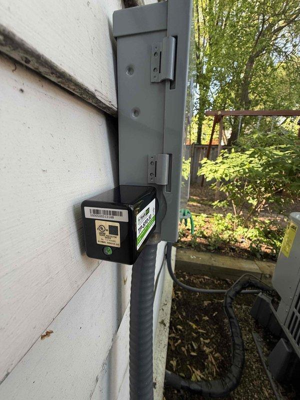 Replaced two existing electrical disconnect boxes on exterior wall with new units and installed two surge protectors to provide equipment protection. All electrical connections were properly secured, conduit runs completed, and system tested for proper operation.
