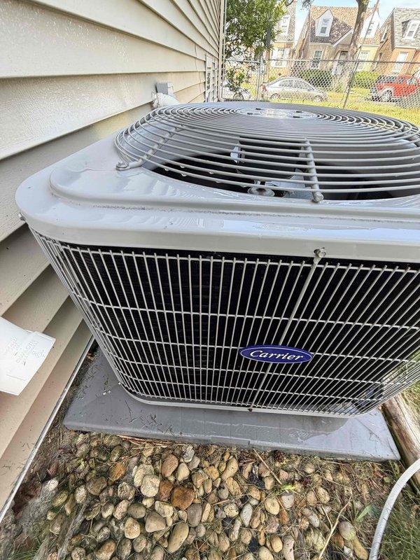 Completed preventive maintenance agreement service on Carrier brand outdoor condensing unit. Performed standard inspection of unit components including condenser coils, fan motor assembly, and electrical connections. Installed new 16x25x1 filter as specified in maintenance agreement. Unit found in good operating condition with no visible damage, proper airflow through grille panels, and clean exterior housing. Concrete pad stable with adequate clearance from structure. Documented equipment condition with photographs for service records.