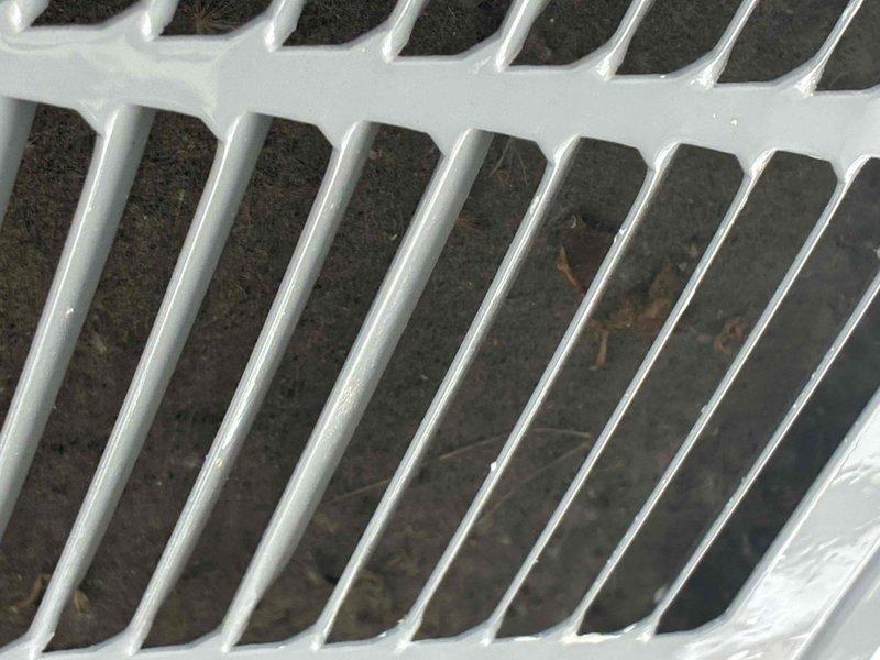 Responded to no cooling complaint on residential AC unit installed in June 2019. Upon inspection, found evaporator coil heavily contaminated with dust, debris, and organic material lodged between fins, severely restricting airflow and heat transfer capability. Cleaned evaporator coil thoroughly to restore proper airflow and system efficiency. Inspected exterior condensate drain connections and plumbing components, which showed normal weathering but remained functional. Verified unit is covered under 10-year parts warranty through Carrier and 10-year labor warranty contingent upon continued annual maintenance. System restored to proper cooling operation.