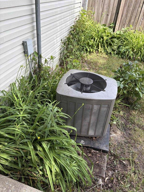 Provided estimate for complete HVAC system replacement including outdoor condensing unit and indoor furnace. Current 10-year-old air conditioning unit located in backyard between house and fence is low on refrigerant due to consistent leaks, making replacement more cost-effective than repair. Customer requested quote for relocating outdoor unit to improved location with better clearance from vegetation and structures. Assessed existing Lennox furnace system in basement and outdoor condensing unit positioned on concrete pad with inadequate clearance from overgrown vegetation. Recommended replacement of both outdoor and indoor equipment to ensure proper system matching, efficiency, and warranty coverage. Discussed optimal placement options for new condensing unit to provide adequate service clearance and airflow while addressing customer's relocation preference.