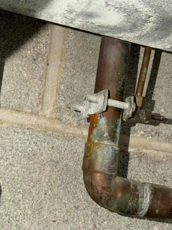 Completed preventative maintenance inspection on air conditioning system under maintenance agreement. Inspected refrigerant lines showing normal patina and oxidation consistent with system age, verified secure mounting and proper penetration through masonry foundation. Evaluated control board operation, confirmed all relays, communication terminals, and humidifier controls functioning properly with no signs of overheating or component failure.
