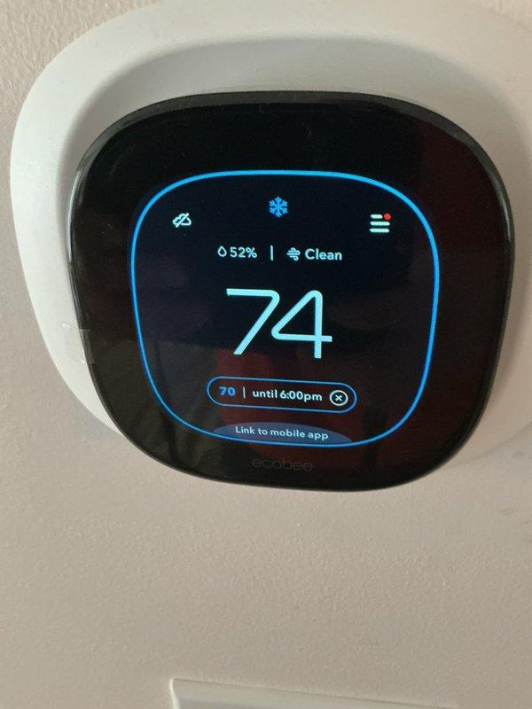 Responded to callback for upstairs dual HVAC system failing to maintain setpoint after recent installation. Upon arrival, verified thermostat programmed to 74°F but space temperature reading 78°F with system actively calling for cooling. Observed ecobee smart thermostat displaying proper cooling mode activation with snowflake icon and scheduled setpoint. Inspected air return grille installation at ceiling location and photographed system components for documentation. System had just cycled on for first time during visit, indicating intermittent operation since original installation completed months prior.