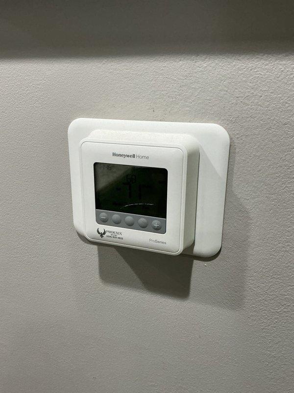 # HVAC Service Call - No Cooling Issue with Zoning Problem

Responded to service call for air conditioning system less than 5 years old experiencing no cooling in one zone and clicking noise upon startup. Upon arrival, conducted visual inspection of thermostat controls and system operation.

Examined Honeywell Home ProSeries thermostat displaying abnormal reading of 99 degrees in heat mode despite cooling season. Verified thermostat wiring connections at wall plate and confirmed proper mounting. Assessed zone control functionality and damper operation for affected area of residence.

Investigated clicking sound reported during system startup by monitoring compressor contactor, relay switches, and capacitor operation. Checked for debris in outdoor unit and inspected fan motor bearings. Evaluated refrigerant pressures and airflow through supply registers in non-cooling zone.

Identified thermostat configuration error causing improper system mode and potential zone damper malfunction rest