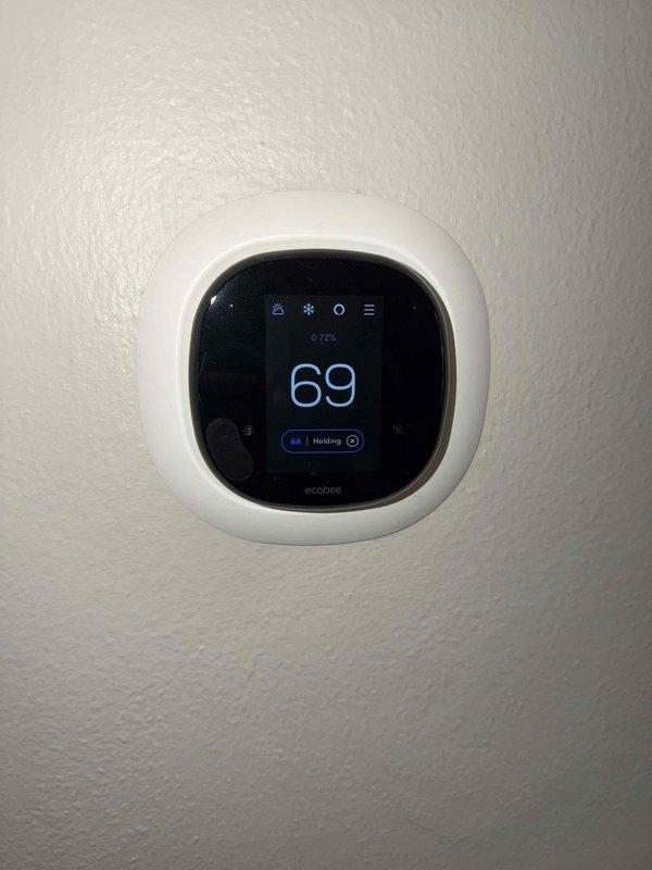 Completed preventative maintenance agreement service on residential cooling system. Performed comprehensive inspection of outdoor condensing unit including visual assessment of cabinet condition, electrical connections, and proper unit placement on concrete pad. Verified thermostat operation and confirmed system holding temperature at programmed setpoint of 66°F with current reading of 69°F displayed on ecobee smart thermostat.