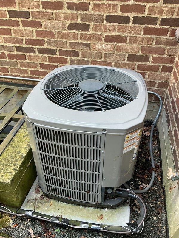 # HVAC Service Call - No Cool, Dual System

Responded to service call for two non-operational air conditioning systems. Upon arrival, performed diagnostic evaluation of outdoor condenser units and indoor thermostat controls. Primary unit inspected showed aged condenser positioned on concrete pad with visible debris accumulation at base. Refrigerant lines and electrical connections evaluated for integrity. Indoor thermostat displayed 81°F ambient temperature with setpoint at 70°F in cooling mode with auto fan setting, confirming lack of cooling operation.

Conducted comprehensive system assessment including electrical supply verification, contactor operation testing, and capacitor evaluation. Both systems exhibited failure to initiate due to age-related component degradation typical of units exceeding 10-year service life. Documented equipment condition through photographic records showing outdoor unit configuration, mounting, and thermostat interface for service history.

Provided cust