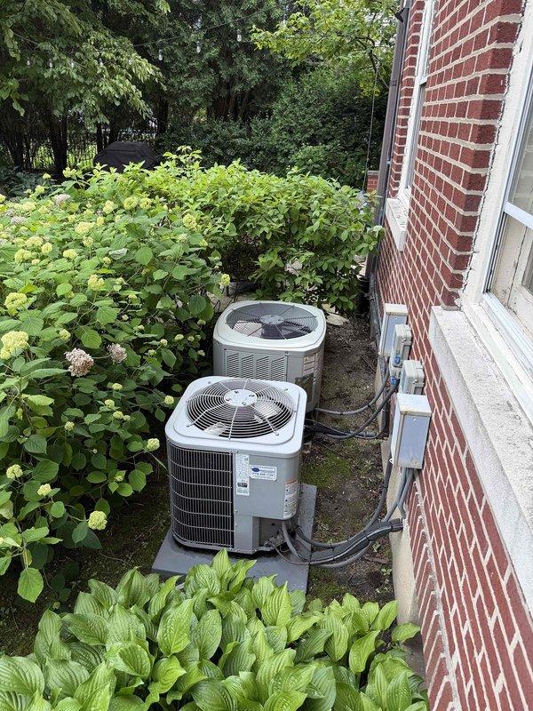 # HVAC Service Report

Responded to no cooling complaint on residential air conditioning system. Upon arrival, found outdoor condenser unit operational but system not producing adequate cooling. Removed front access panel to inspect internal electrical components and capacitor. Verified proper refrigerant line connections and electrical conduit routing. Unit showed normal outdoor weathering with minor debris accumulation in base pan. System located on concrete pad with proper clearances maintained from surrounding landscaping and building structure.