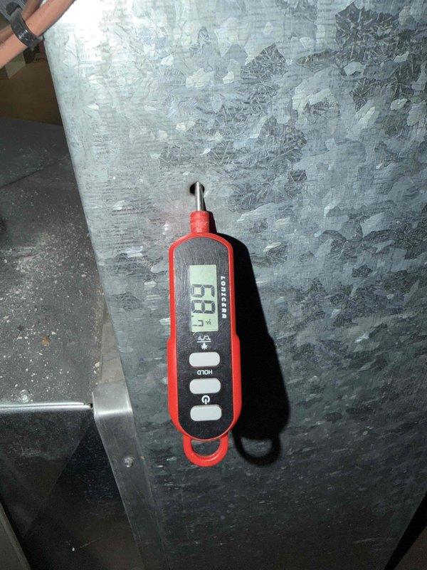 Completed cooling check on air conditioning system under maintenance agreement. Inspected blower wheel assembly, which showed normal dust accumulation consistent with operational use, and verified proper blade condition. Measured supply air temperature at 63°F, confirming adequate cooling performance and system functionality within normal operating parameters.
